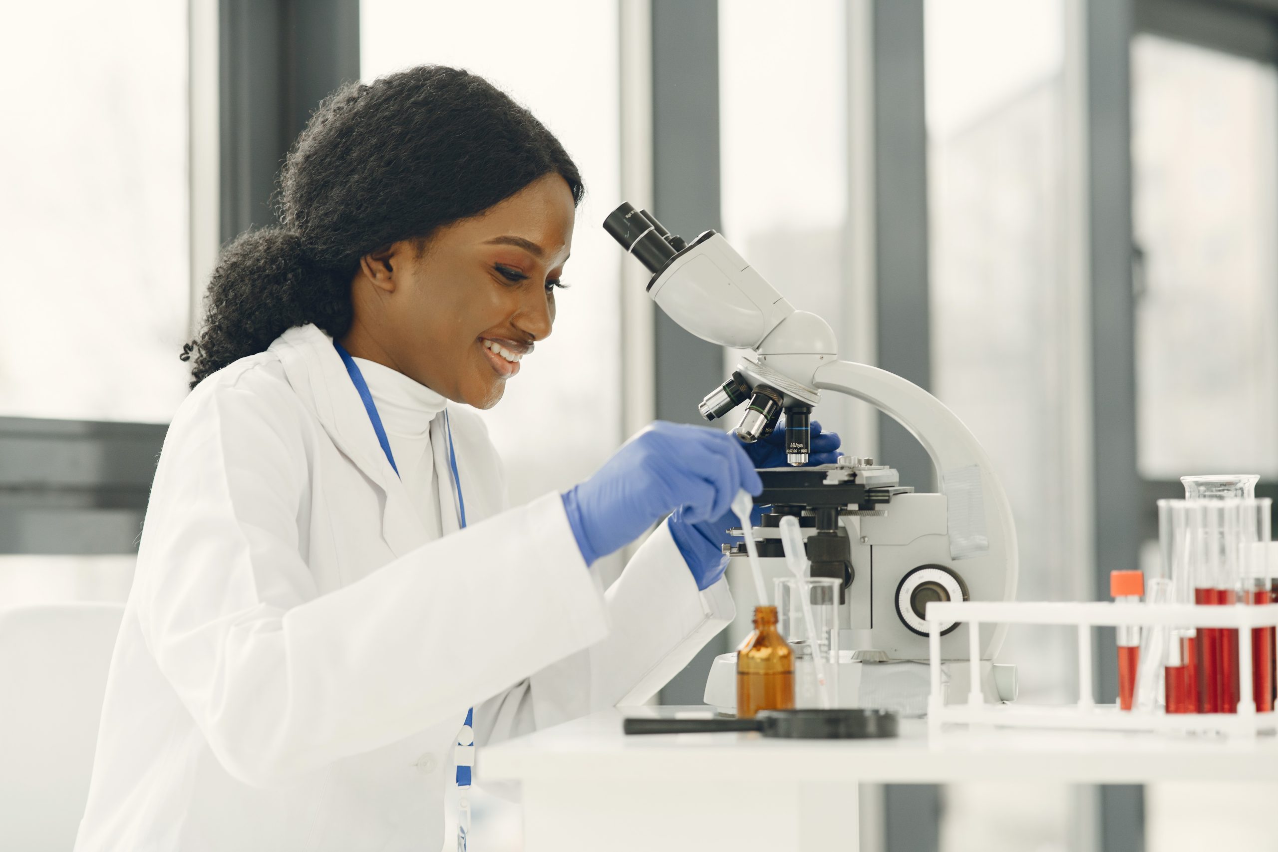 female scientist working in the laboratory using a microscope